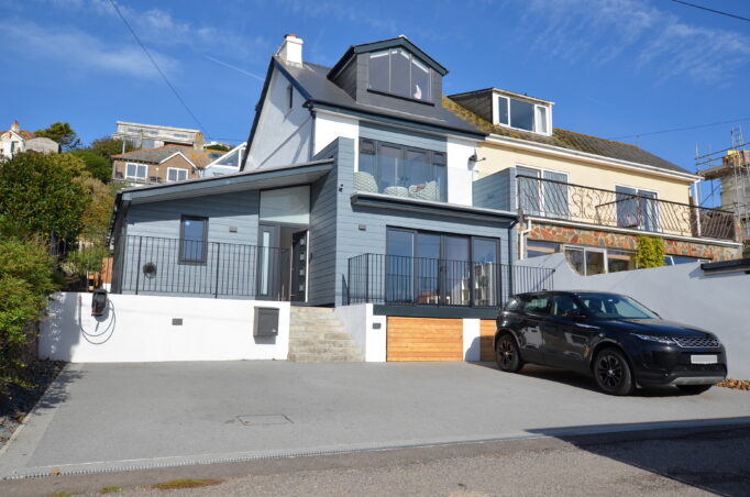 Exterior photo of renovated victiorian property to contemporary home with balconies and dormer