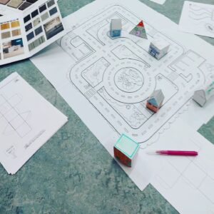 Paper city, imagined road layout and with paper models of houses, hotels, vets etc
