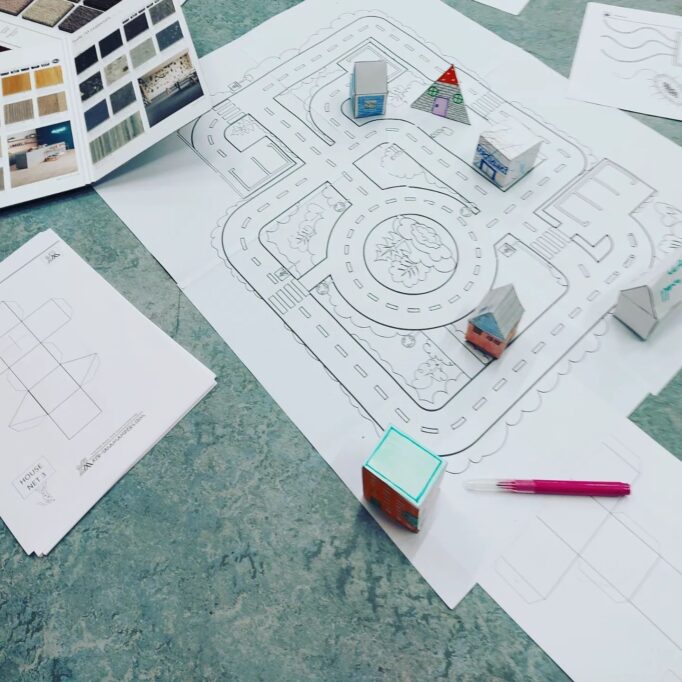 Paper city, imagined road layout and with paper models of houses, hotels, vets etc