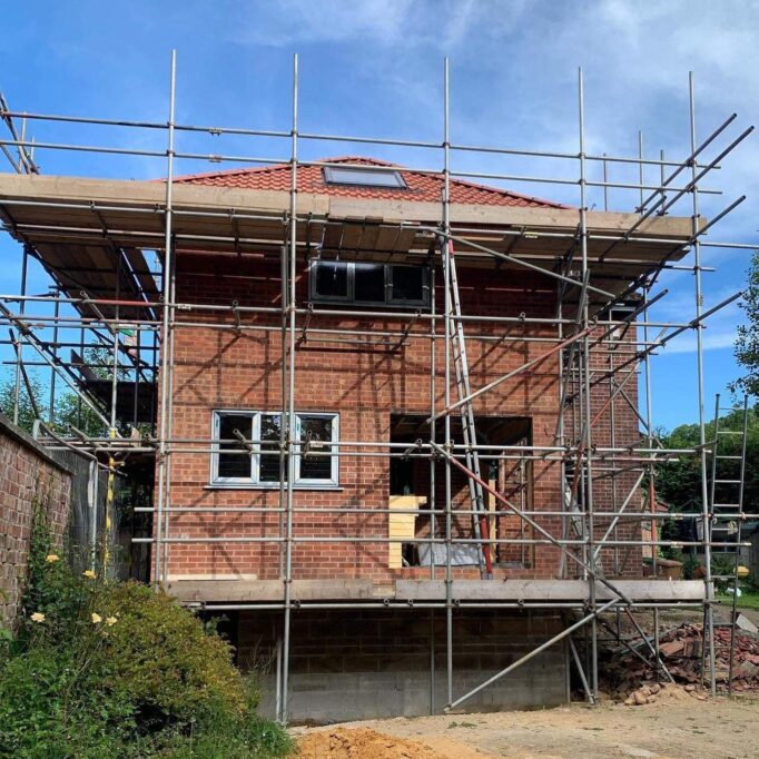 scaffold detached brick house blue sky crayon architects