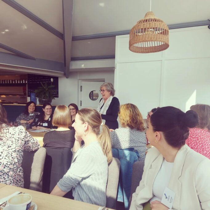 Breakfast meeting with honorary president Theresa standing up making her speech